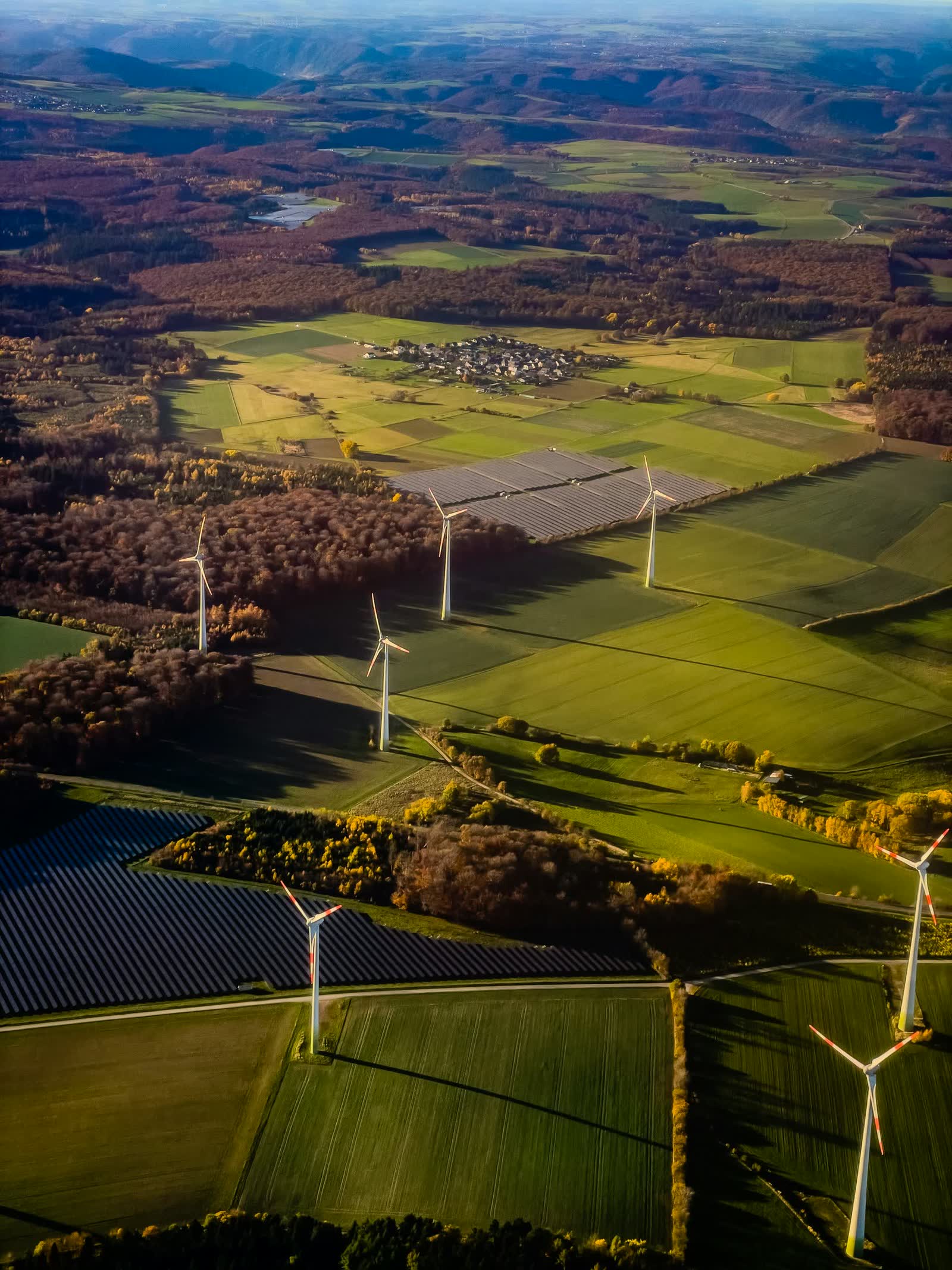 Wind turbines and solar panels across farmland