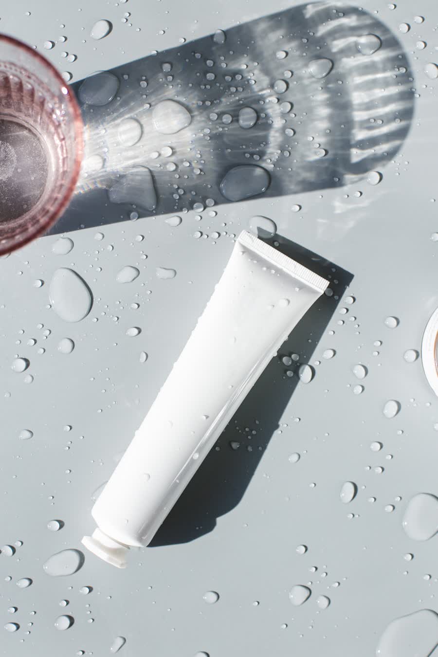 Cosmetic tube with water droplets